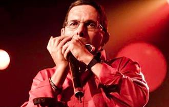 Adam Glasser performing on harmonica