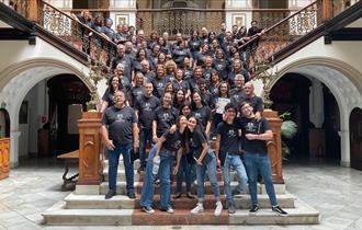 Subito Koral - mixed choir posed on large staircase