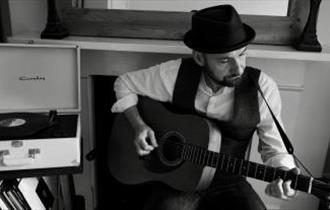 Richard Anderson playing guitar