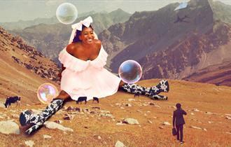 Giant Sophie Duker sat on a mountainside