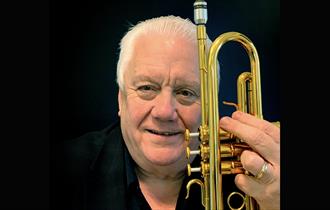 Bruce Adams - holding a trumpet