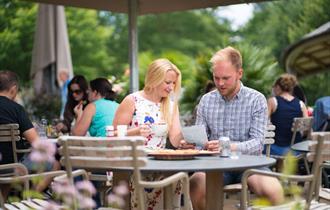 Visitors looking at the menu on the terrace of The Savill Garden Kitchen