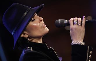 Jo Harrop singing into a microphone