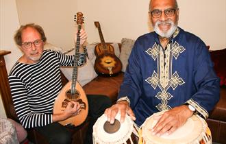 Mark and Iqbal posing with instruments