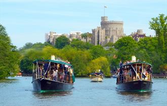 French Brothers boats on the River Thames with Windsor Castle in distance