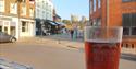 Pint of beer in front of window at the George Inn, Eton