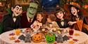 Little Monsters Breakfast Banquet | children with Halloween characters at a dining table