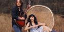 Hannah Sanders and Ben Savage in cornfield with wicker chair
