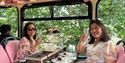 Two people enjoying afternoon tea on Golden Tours Royal Windsor Afternoon Tea Bus Tour