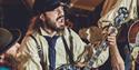 Old Time Sailors - band playing banjos while singing in old outfits