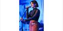 SpitNights Headline - woman at microphone stand