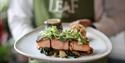 The Castle Hotel Windsor | waiter serving seared Scottish salmon