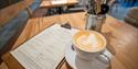 Cup of coffee and menu on table | Windsor Farm Shop Café