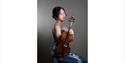 Yume Tomita ©Kan Tomita - sat in evening gown holding violin