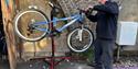 bike kitchen, man working on bicycle