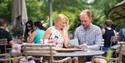 Visitors looking at the menu on the terrace of The Savill Garden Kitchen