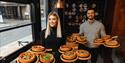 The founders of Japes Pizza holding pizzas
