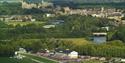 Aerial view of Royal Windsor Racecourse with River Thames and Windsor Castle in distance