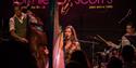 Tara Minton - performing on stage at Ronnie Scott's with harp