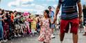 TOTfest | girl carrying ice cream and walking hand in hand through bubbles