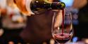 Red wine being poured into a glass