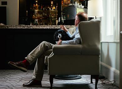 Man with dog in Taplow House Hotel bar