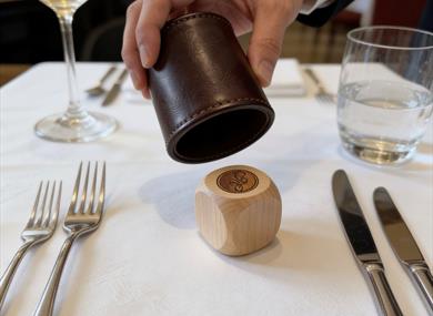 Person rolling a dice