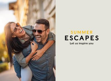 Man giving woman a piggy back.  Castle Hotel Windsor summer escapes promotion