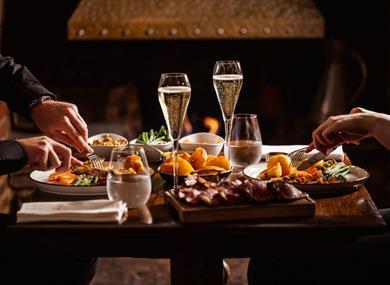 People eating and drinking at The Hind's Head