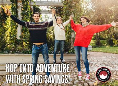 Two adults lifting a child into the air