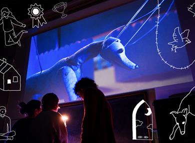 Bark Bark - people in front of a projection of a puppet dog, with doddles around the image