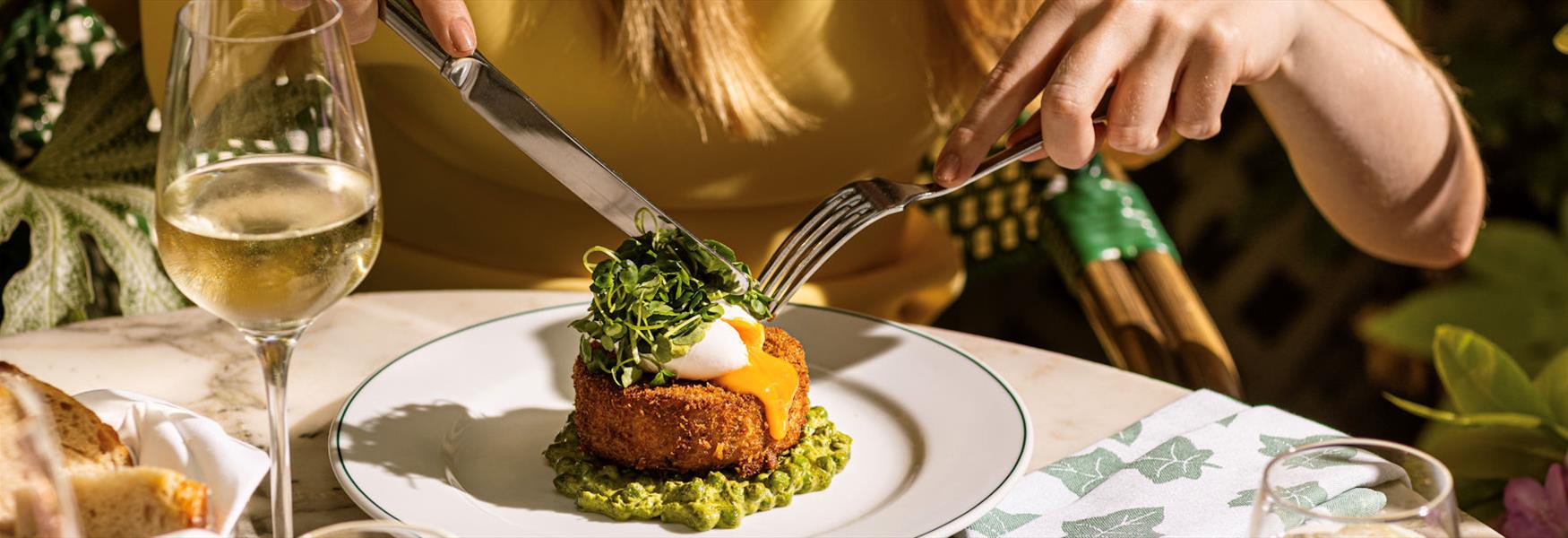 Person eating food at The Ivy