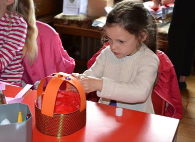 Little girl taking part in a craft activity at Windsor Castle