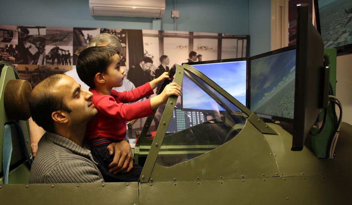 Maidenhead Heritage Centre: man and boy enjoying the Spitfire Simulator