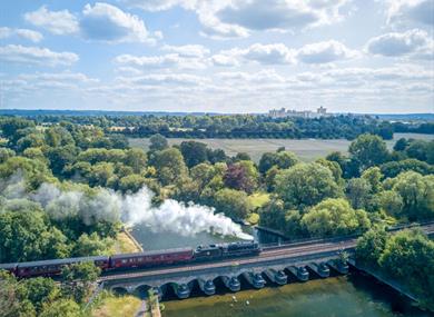 The Royal Windsor Steam Express with Windsor Castle in the distance