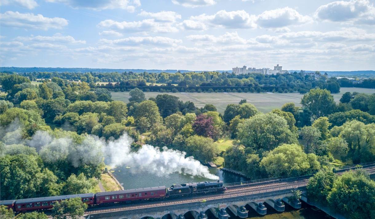 The Royal Windsor Steam Express with Windsor Castle in the distance