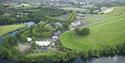 Aerial view of Royal Windsor Racecourse with River Thames in foreground.