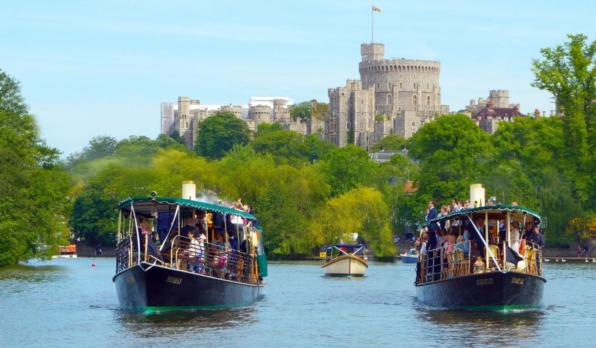 French Brothers boats on the River Thames with Windsor Castle in distance