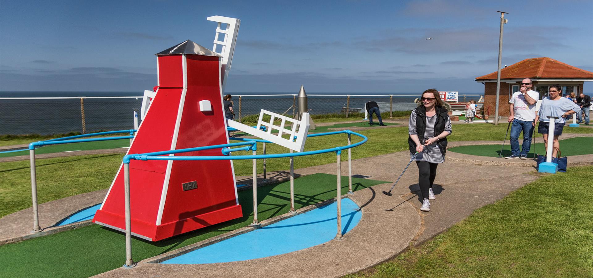 An image of Family playing mini golf - Richard Burdon