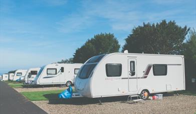 An image of a row of white caravans