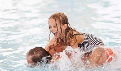 An image of people swimming at Blue Dolphin Holiday Park