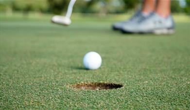 Image of a man putting a golf ball