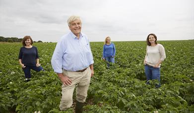 An Image of the Bannisters family standing in a field at Bannisters Yorkshire Family Farm