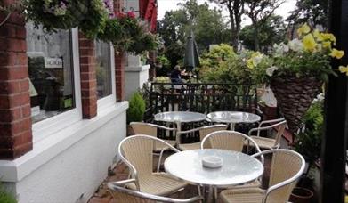 An image of Pheonix Guest House - outdoor seating front of house