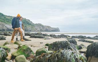 An image of a couple on Sandsend beach