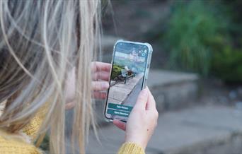 An image of a women playing Mega Mini Beasts game
