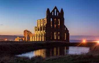 An image of Whitby Abbey at dusk