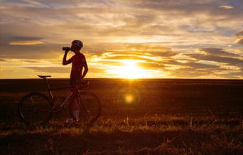 An image of a cyclist at sunset