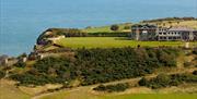 An image of Raven Hall Country House Hotel from a far