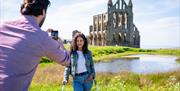 An image of visitors at Whitby Abbey. Credit: VisitBritain/ Peter Kindersley